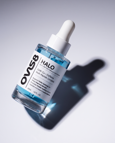 HALO hair serum bottle in flash light